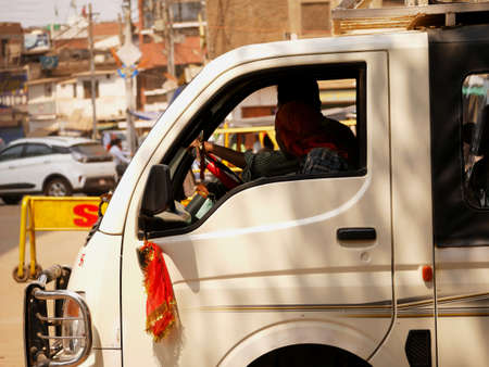 Transportation vehicle driving chamber close up at city traffic environment. white color van driving side view image concept at city Katni Madhya Pradesh in India on March 2022.のeditorial素材