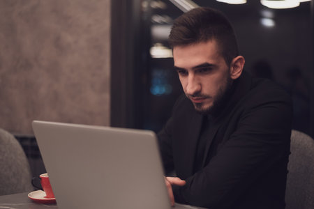 Young business man working on a laptop at his office during the night. High quality photoの写真素材