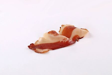 dried bacon slice on whitle background isolatedの写真素材