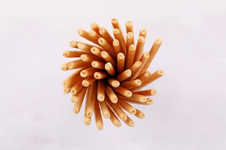 broken salty bread stick crumbs on white background isolated top view