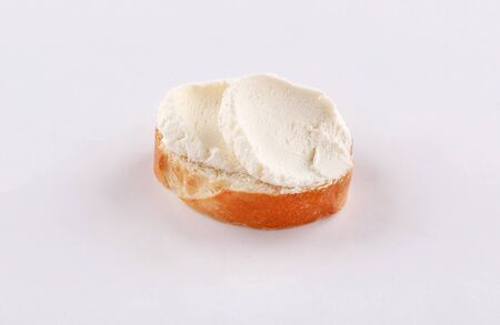 little baguette bread slice with spread cheese on white backgroundの写真素材