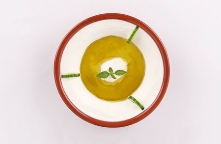 labneh traditional oriental dish, with herbs and cucumber, olive oil on white backgroundの写真素材