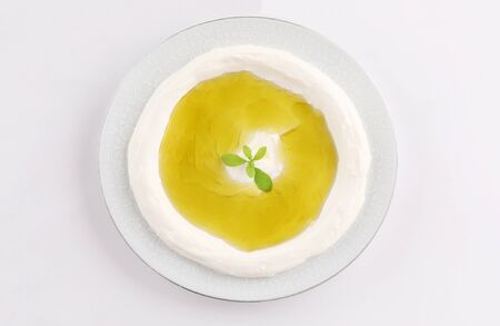 traditional oriental dish, labneh bowl, dish with olive oil on white backgroundの写真素材