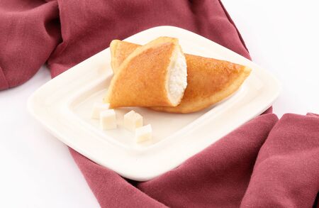 qatayef Ramadan Traditional Sweets chesse plate on napkin vinous isolated on white backgroundの写真素材