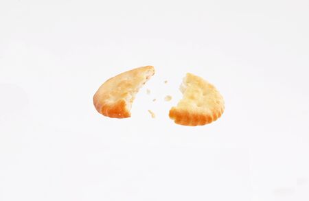 broken crackers biscuits fly isolated on white backgroundの写真素材