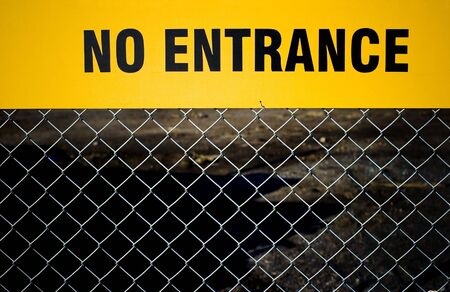 "No Entrance" sign on a fence.の写真素材