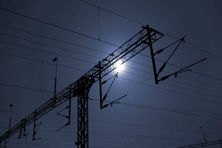 High voltage train powerlines against skyの写真素材