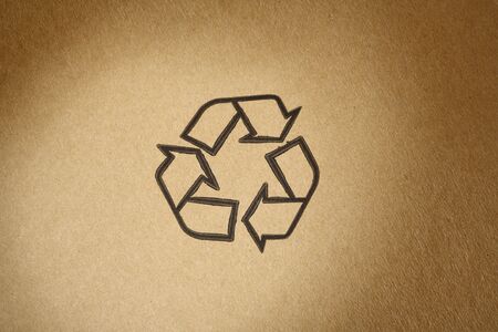 "Recyclable" universal symbol, printed on brown cardboardの写真素材