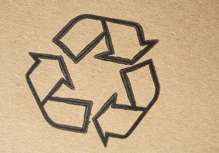 "Recyclable" universal symbol, printed on brown cardboardの写真素材