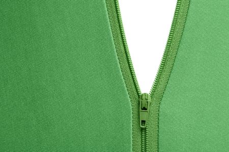 Zipper of a green garment revealing a white surfaceの写真素材