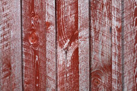 Wooden wall with worn red paintの写真素材