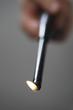 A Hand using a butane fireplace lighterの写真素材