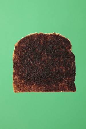 A Slice of burnt toast bread on greenの写真素材