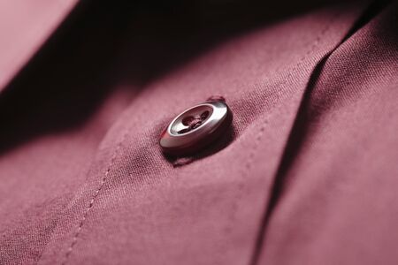 Button of a dark red new shirtの写真素材