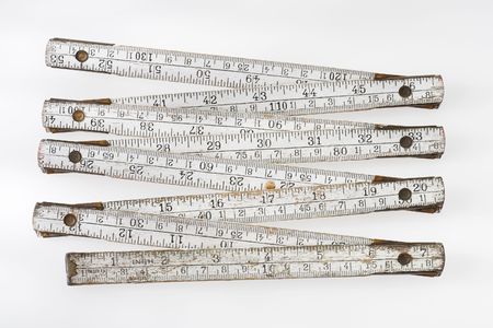 Old and dirty folding carpenter's ruler on light grey backgroundの写真素材