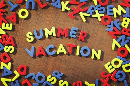 Words "Summer Vacation" written with plastic fridge magnet letters.の写真素材