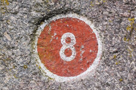 Number 8 painted inside a red circleの写真素材
