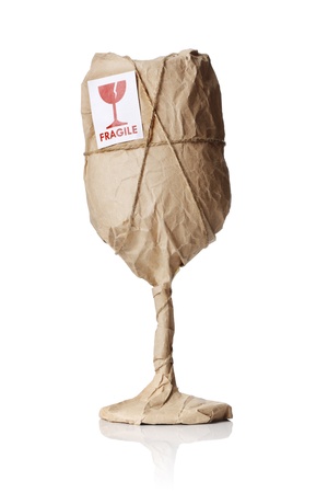 A Wine glass packaged in brown wrapping paper with "Fragile" warning sticker.の写真素材