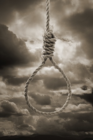 Sepia toned photograph of a hangman's Noose against cloudy sky.の写真素材