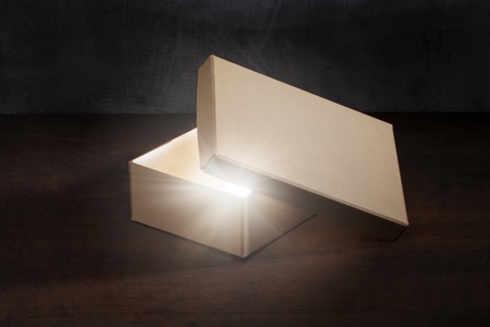 Mysterious old shoe box with glowing contents.