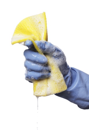Man holding a soapy wet yellow cleaning cloth in his hand.の写真素材