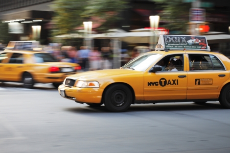  NEW YORK CITY, USA - JUNE 8: Yellow New York taxi cab driving on a street. June 8, 2012 in New York...