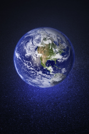 A Glowing earth on asphalt road. Earth image provided by NASA.の写真素材