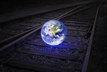 Glowing earth on an old railroad track. Earth image provided by NASA.の写真素材