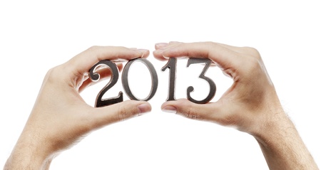 Man holding metallic numbers for year 2013 in his hands.