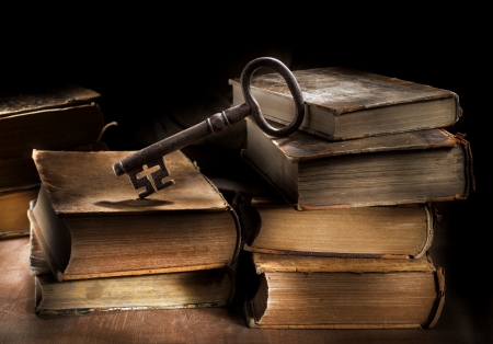 Conceptual still life image of old antique books and a big old key.の写真素材