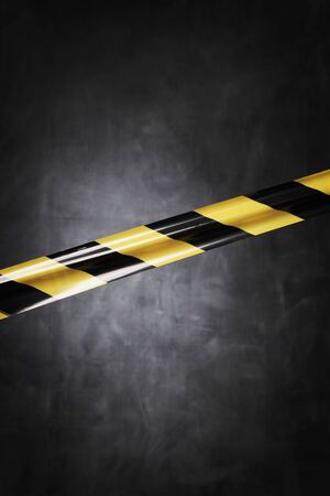 Black and yellow plastic barrier tape blocking the way.の写真素材