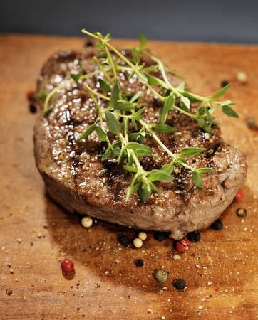 Fried beef tenderloin steak with thyme and peppers.の写真素材