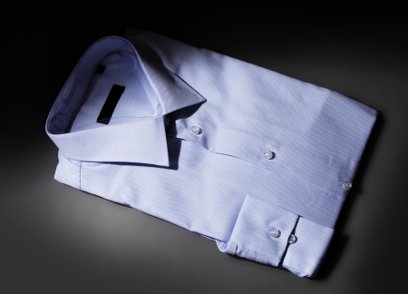 Men's New blue dress shirt in spotlight.の写真素材