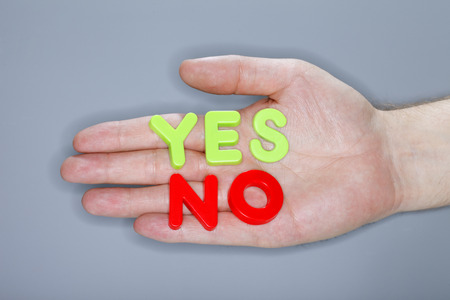 Words YES and NO written with plastic letters and photographed with a ring flash.