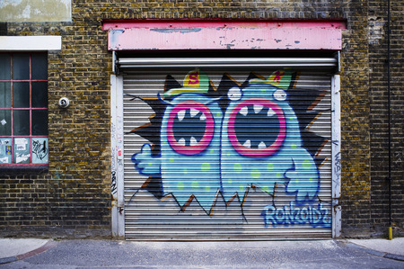 LONDON, UK - APRIL 18, 2014: Graffiti, posters and stickers on Fashion Street, Spitalfields / Whitechapel.のeditorial素材