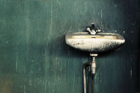 Old dirty sink in an abandoned factory.の写真素材