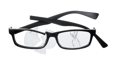 Cheap plastic reading glasses broken on white background.の写真素材