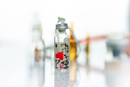 Medicine bottle with pills over withe backgroundの写真素材