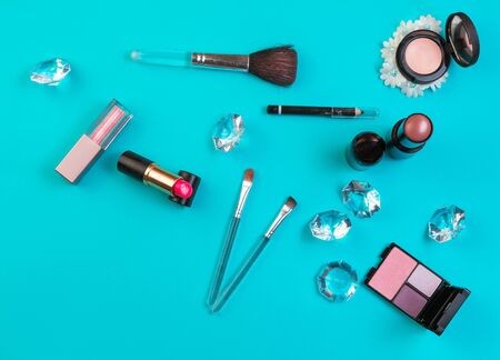 Feminine make up tools over cyan background