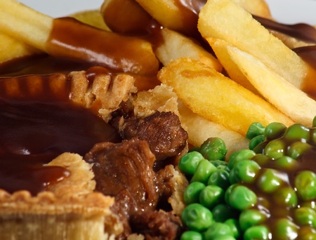 Close up of Steak Pie and chips with peas and gravy  A traditional British Dishの写真素材