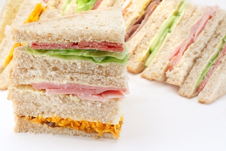 Selection of Sandwiches in front of a platter of various fillings at buffetの写真素材