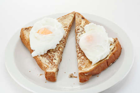Two poached eggs on toast trianglesの写真素材