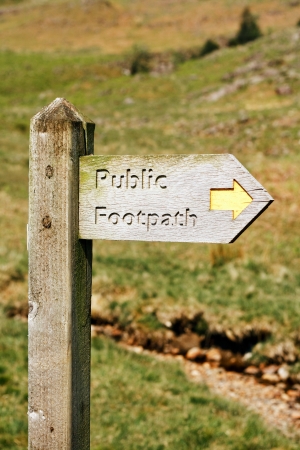 Old wooden footpath sign in the Lake Districtの写真素材