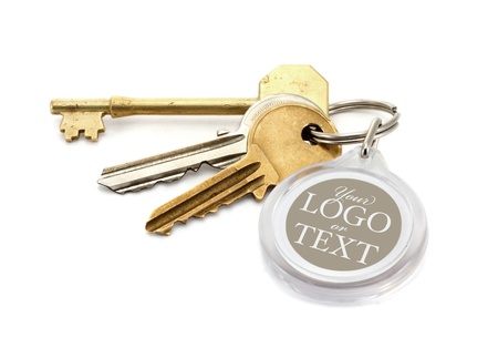 A set of worn house keys with clear plastic Key fob or tab with copy space for adding of text message or estate agents company logo and details.の写真素材