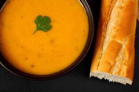 Carrot and coriander soup with bread stickの写真素材