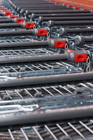 Rows of unbranded shopping trollies at the supermarketの写真素材