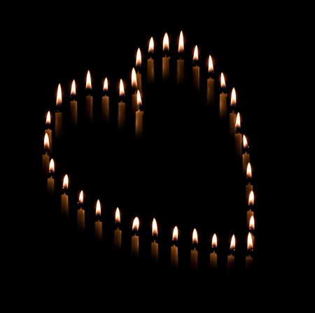 Candles in heart shape symbolizing romanceの写真素材