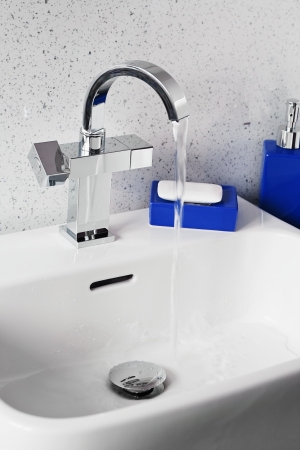 Mixer tap on a contemporary modern bathroom sinkの写真素材