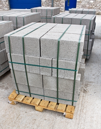 Pallets of breeze blocks at a construction site from a builders merchant known as cinder blocks in the us or Concrete masonry unitsの写真素材