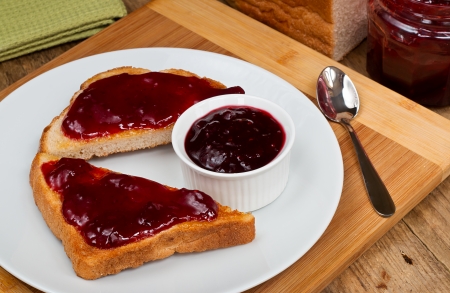mixed fruit jam on toast in a rustic table top farmhouse settingの写真素材